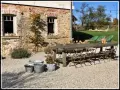 Rusty metal chairs await guests at a rustic table, perfect for enjoying the charm of agroturystyka Dolny Śląsk.